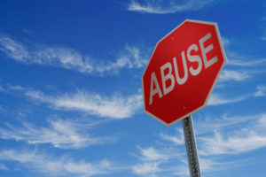 Domestic Violence Statistics - Stop sign with the word ABUSE on it